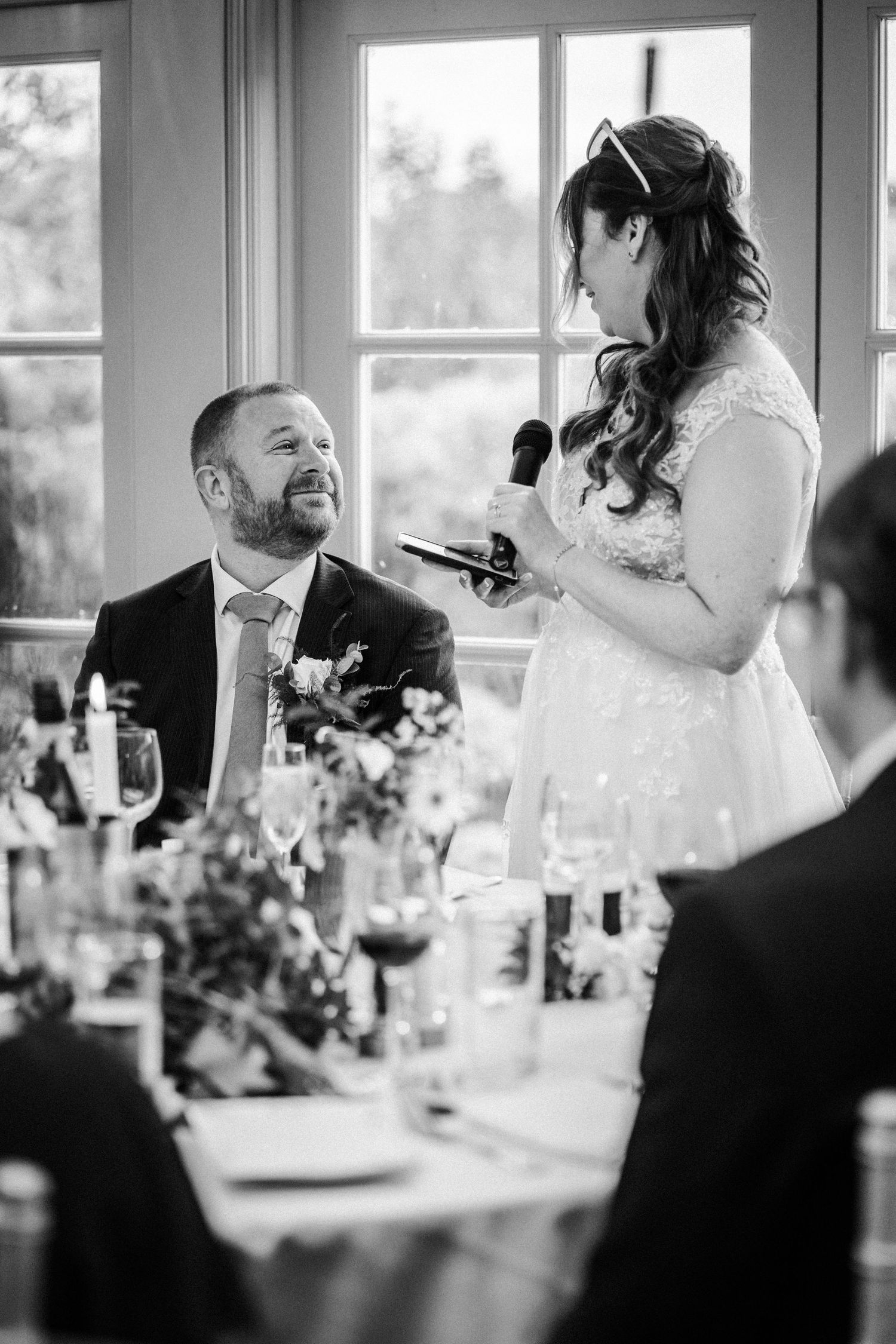 Wedding reception candid moments captured in black and white through a series of four connected photos.