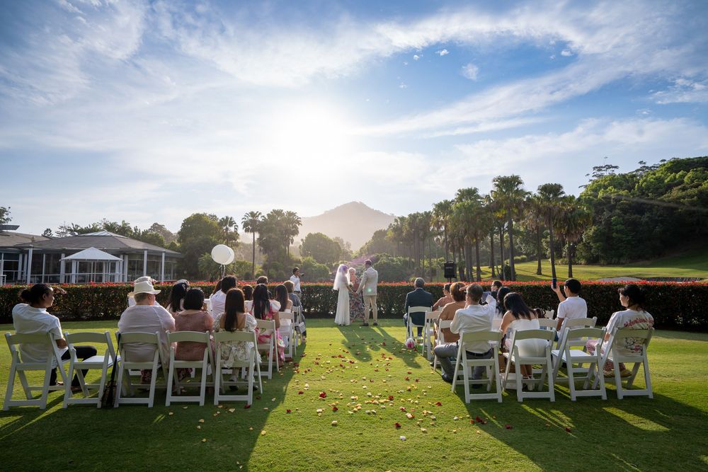 Panoramic sequence of an outdoor wedding ceremony on a lush green lawn during golden hour with white chairs and guests.
