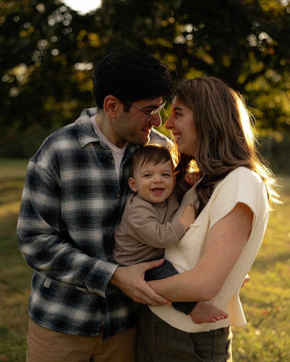 Family sharing tender moments during sunset outdoor photo session.