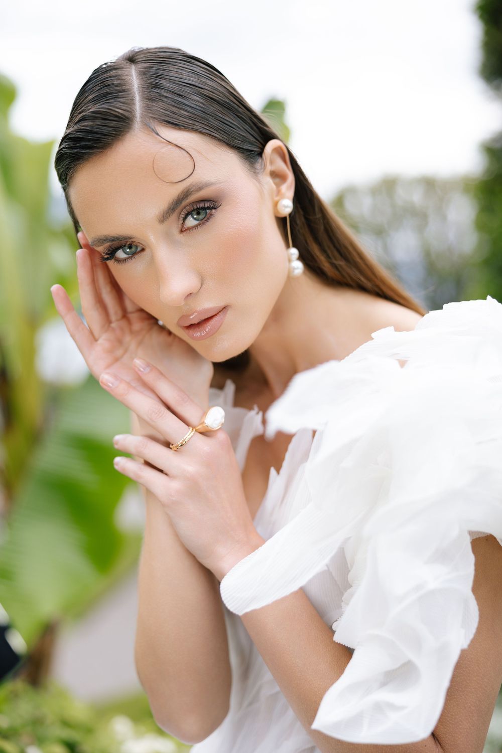 Close-up portrait shots showing delicate white ruffled fabric and soft natural lighting against a green background.