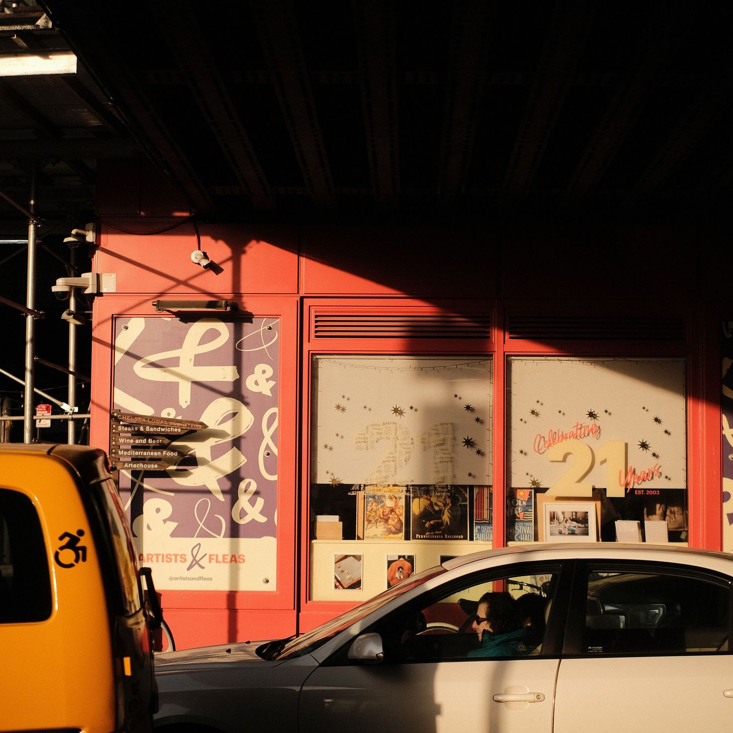 Colorful murals and artwork line the walls of a dimly lit urban space.