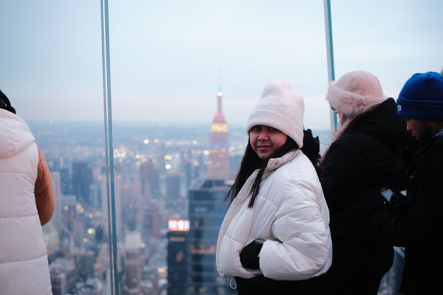 People gathered at observation deck viewing platform overlooking city panorama.
