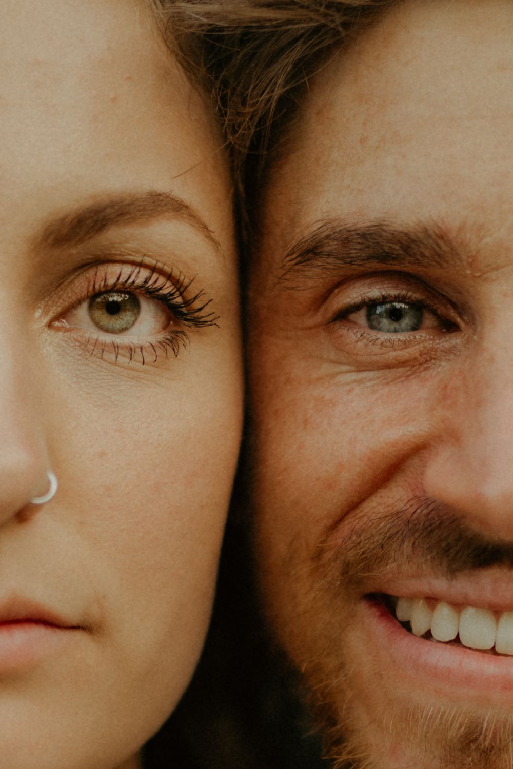 Close-up artistic portrait showing eyes and smiles in warm tones.