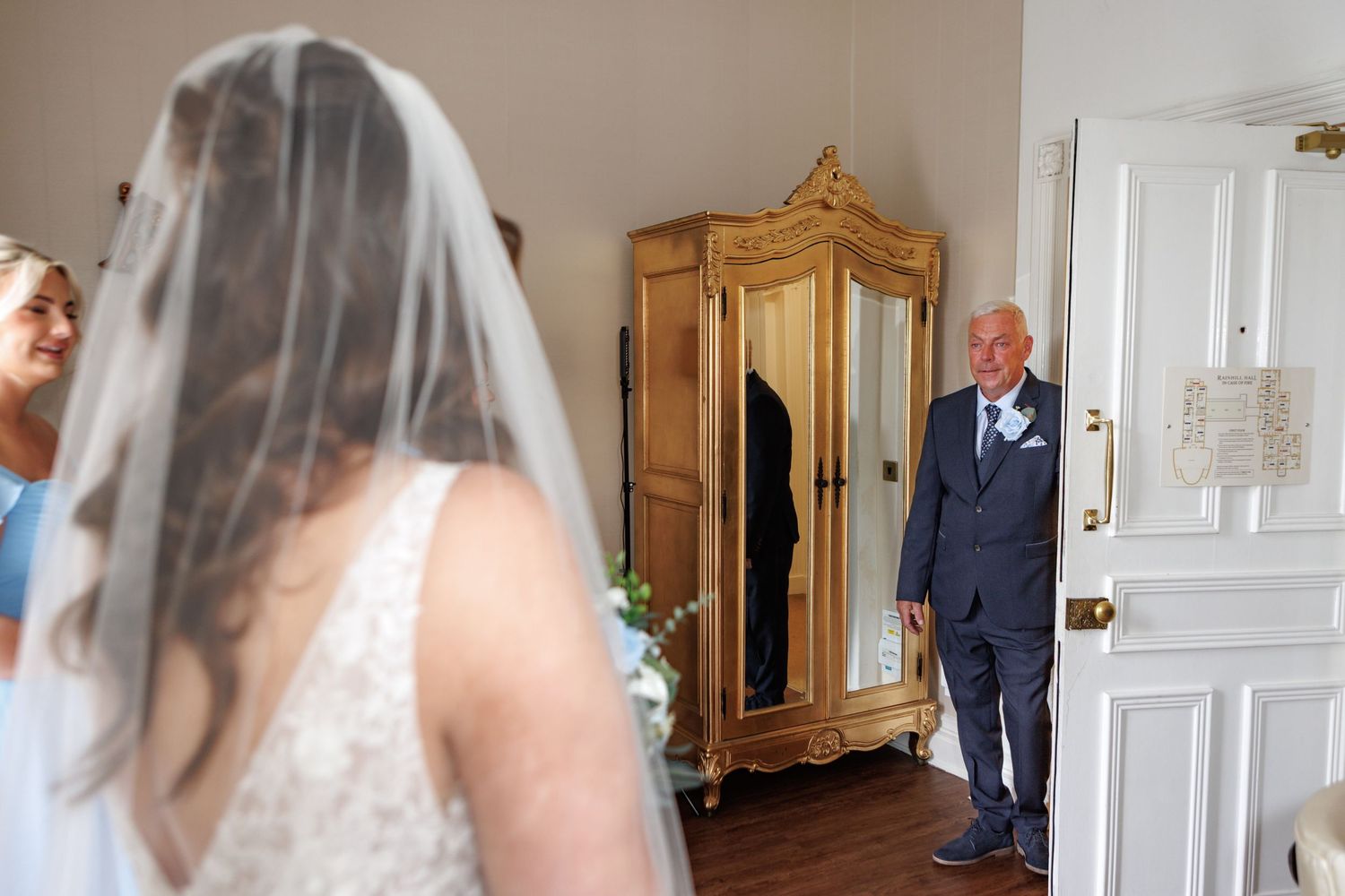 Elegant wedding photo sequence showing a bride and groom's emotional first look in a bright white room.