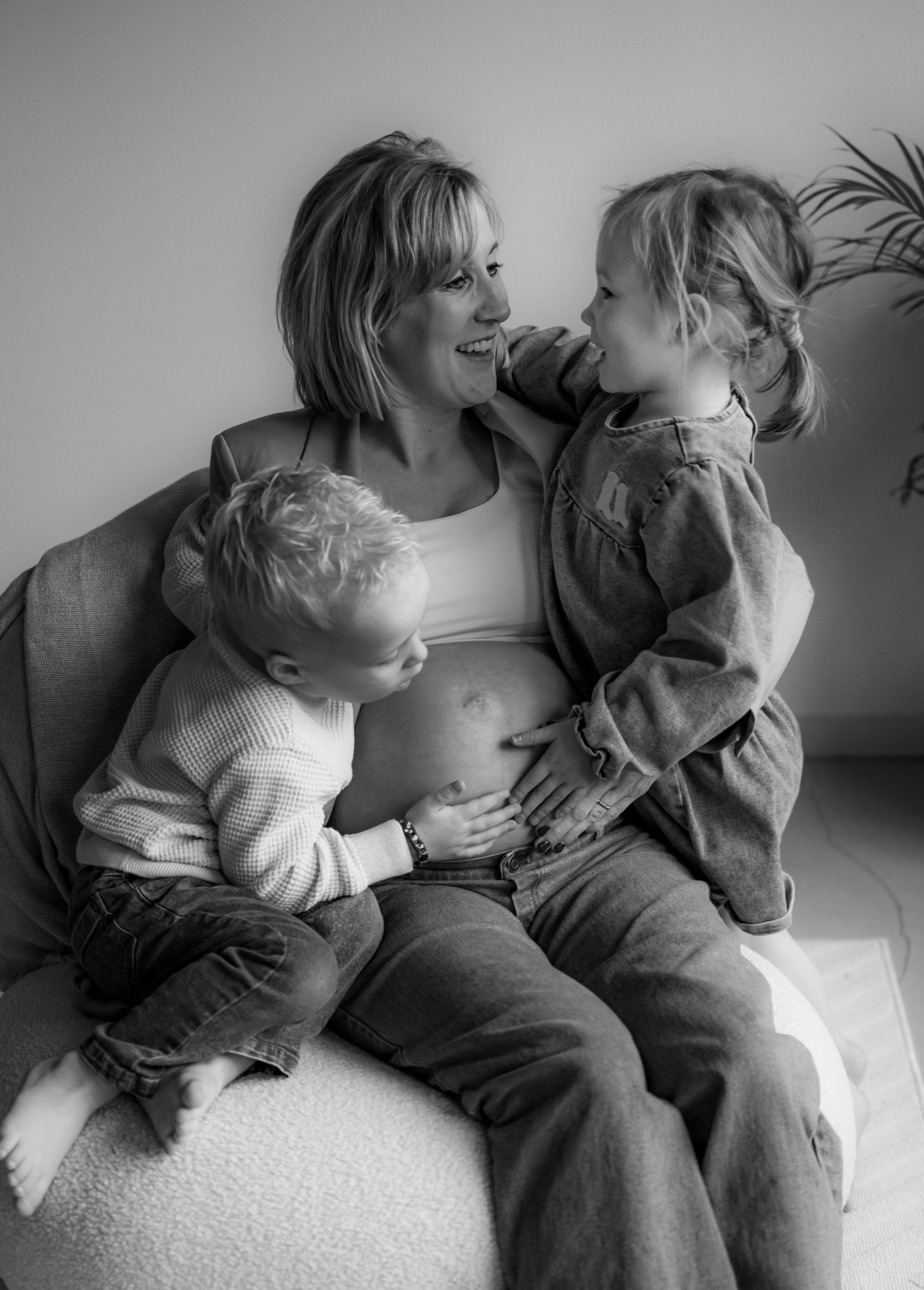 Black and white series of family bonding moments on comfortable seating.