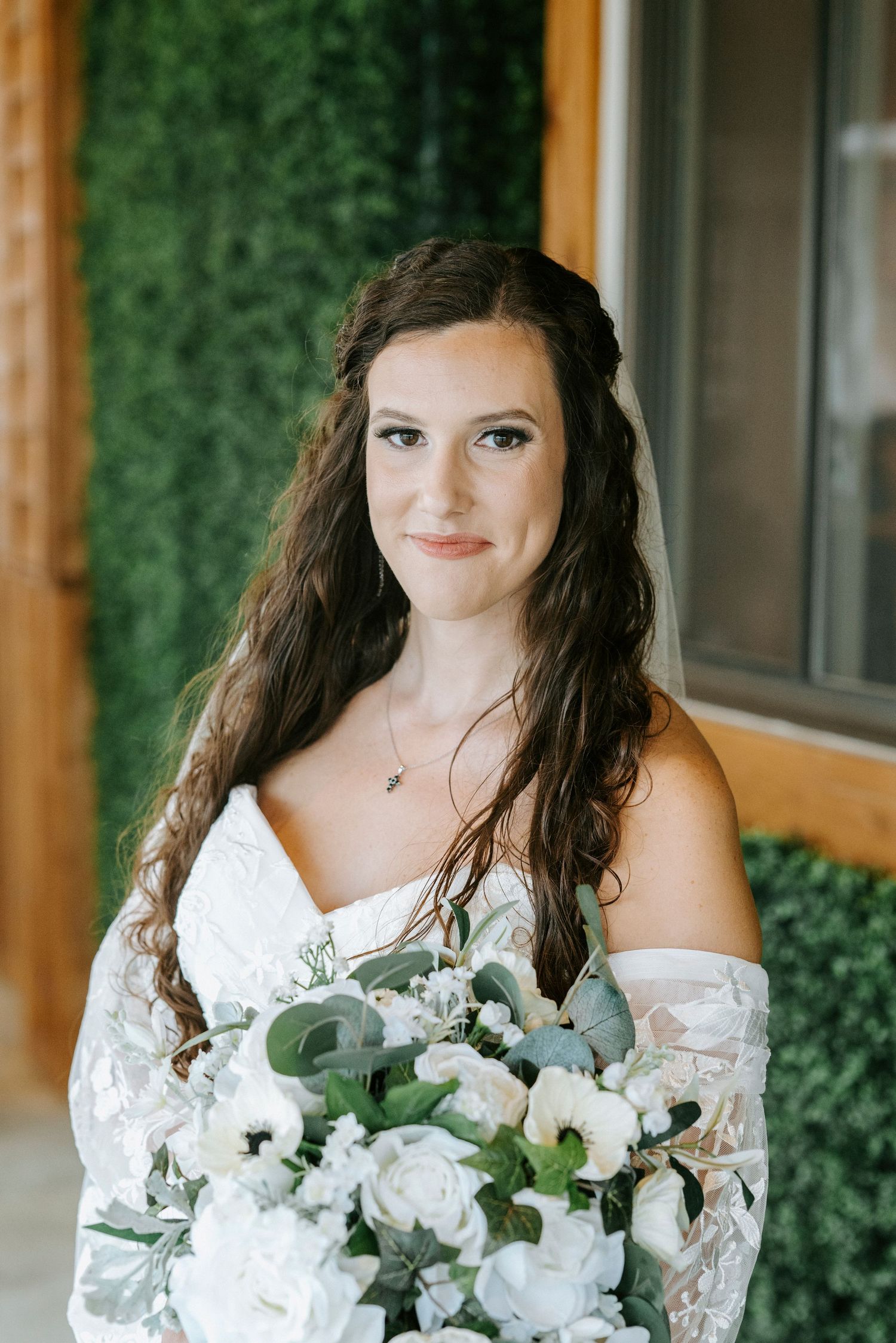 A bridal portrait series featuring white floral bouquet with eucalyptus leaves against a green wall backdrop.