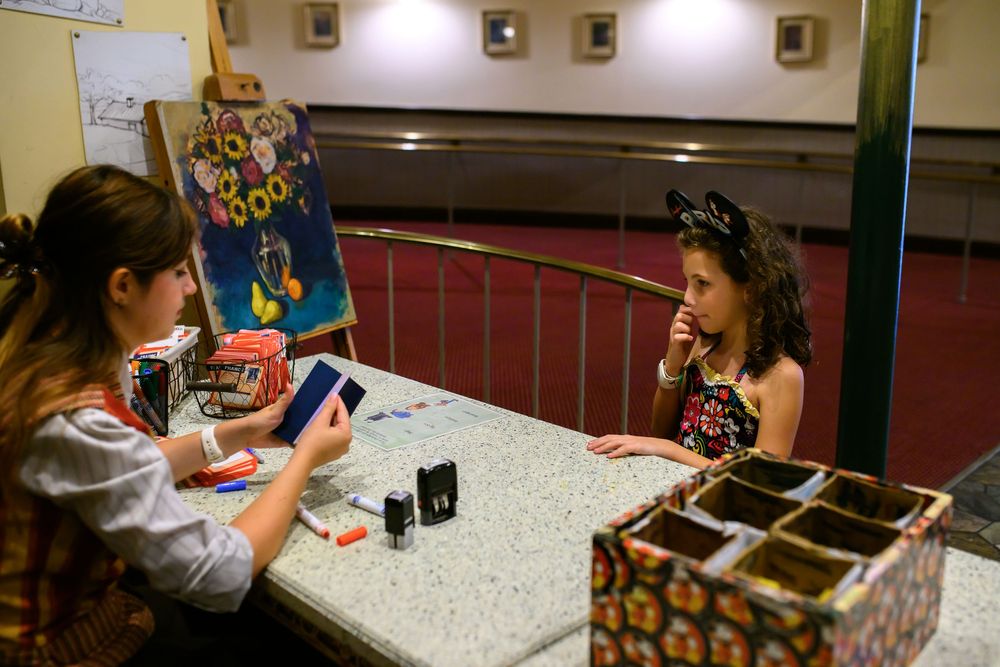 Students work together at tables in a classroom setting, engaging in various educational activities and projects.