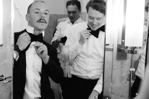 Three black and white photographs show people in white shirts smoking and socializing in what appears to be an office setting.