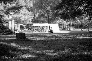 Black and white panoramic view of a historical reenactment campsite with tents.