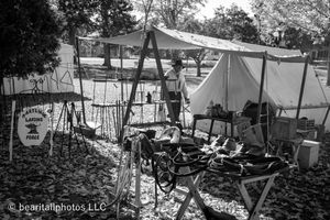 Black and white panorama of Civil War era encampment with multiple tents and period equipment.