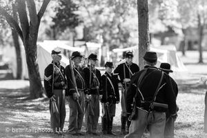 Civil War soldiers in formation during a historical reenactment event.