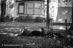 Historic Victorian house with bay windows photographed in black and white panoramic style.
