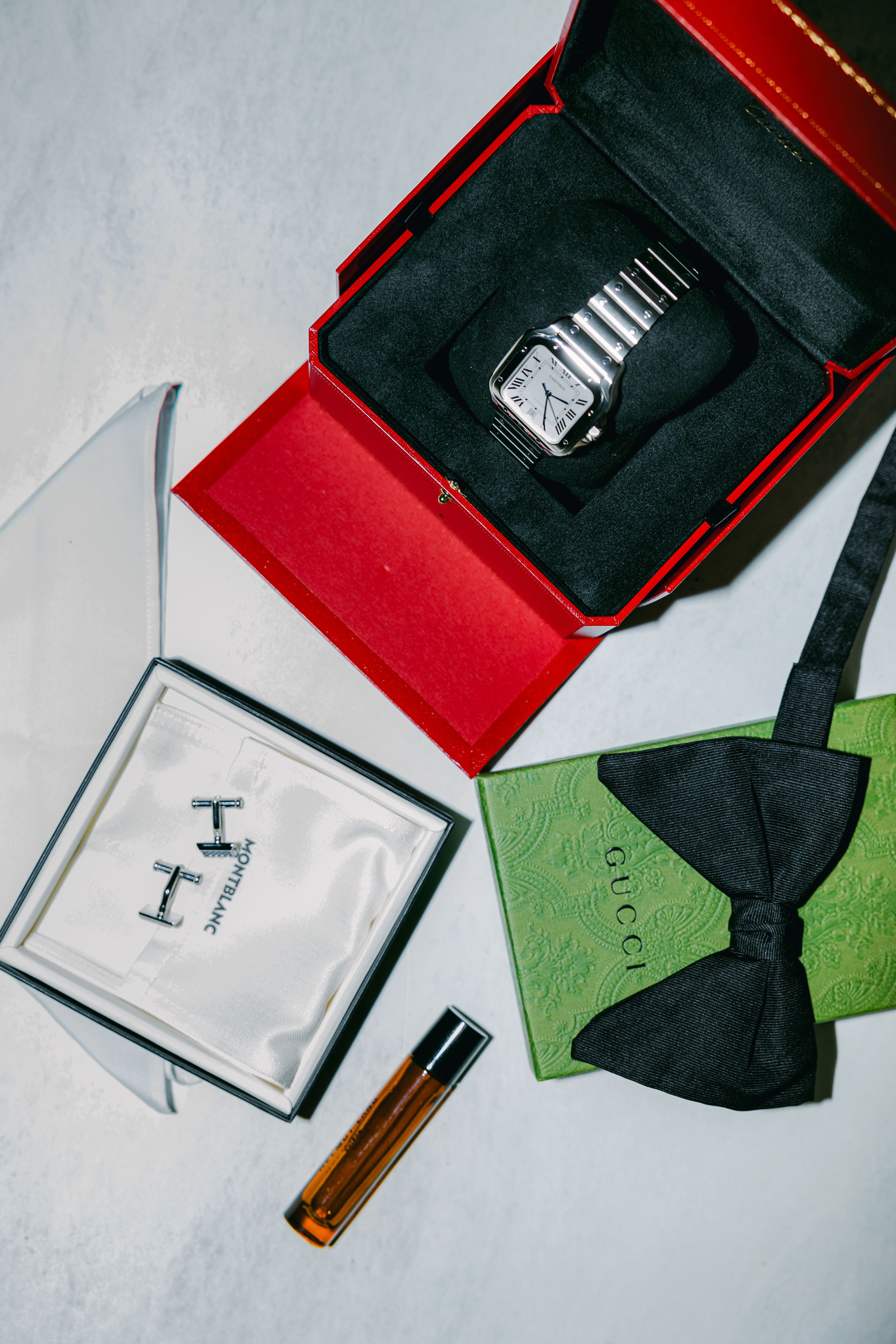 Artistic composition of red and black boxes with a green surface and white elements arranged in a minimalist style.
