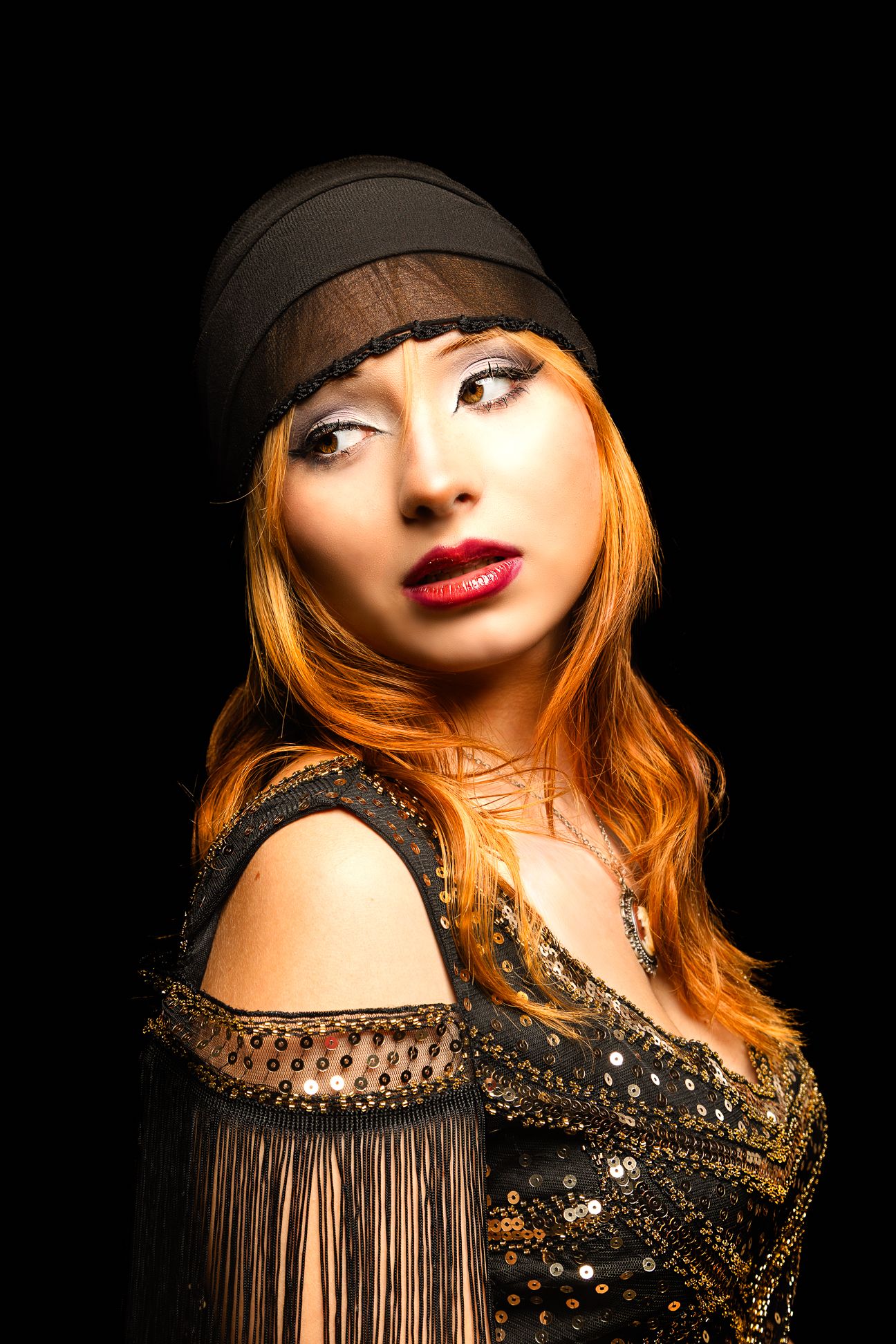 Coloured photo of a girl with a headscarf on, looking left