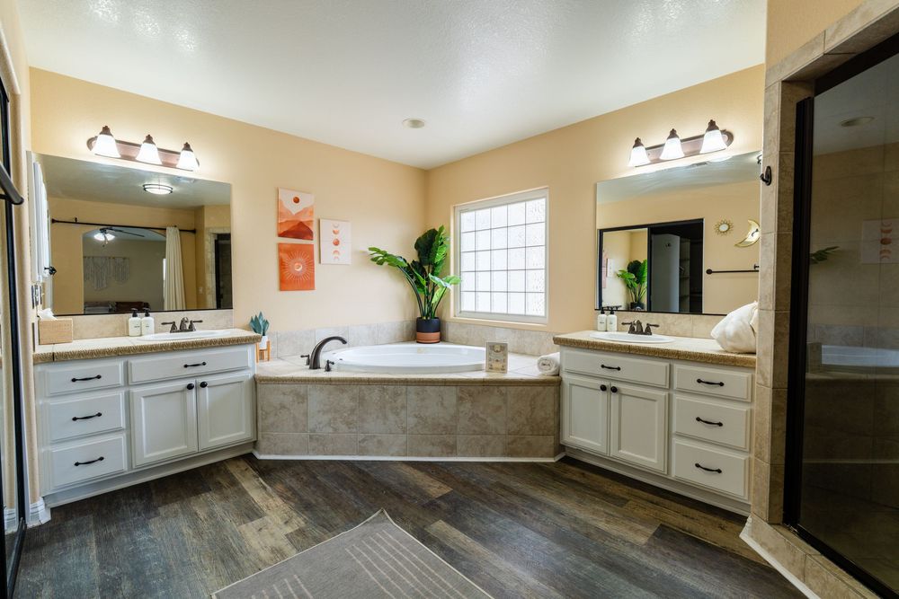 Modern white kitchen remodel features custom cabinetry, granite countertops and stainless steel appliances.