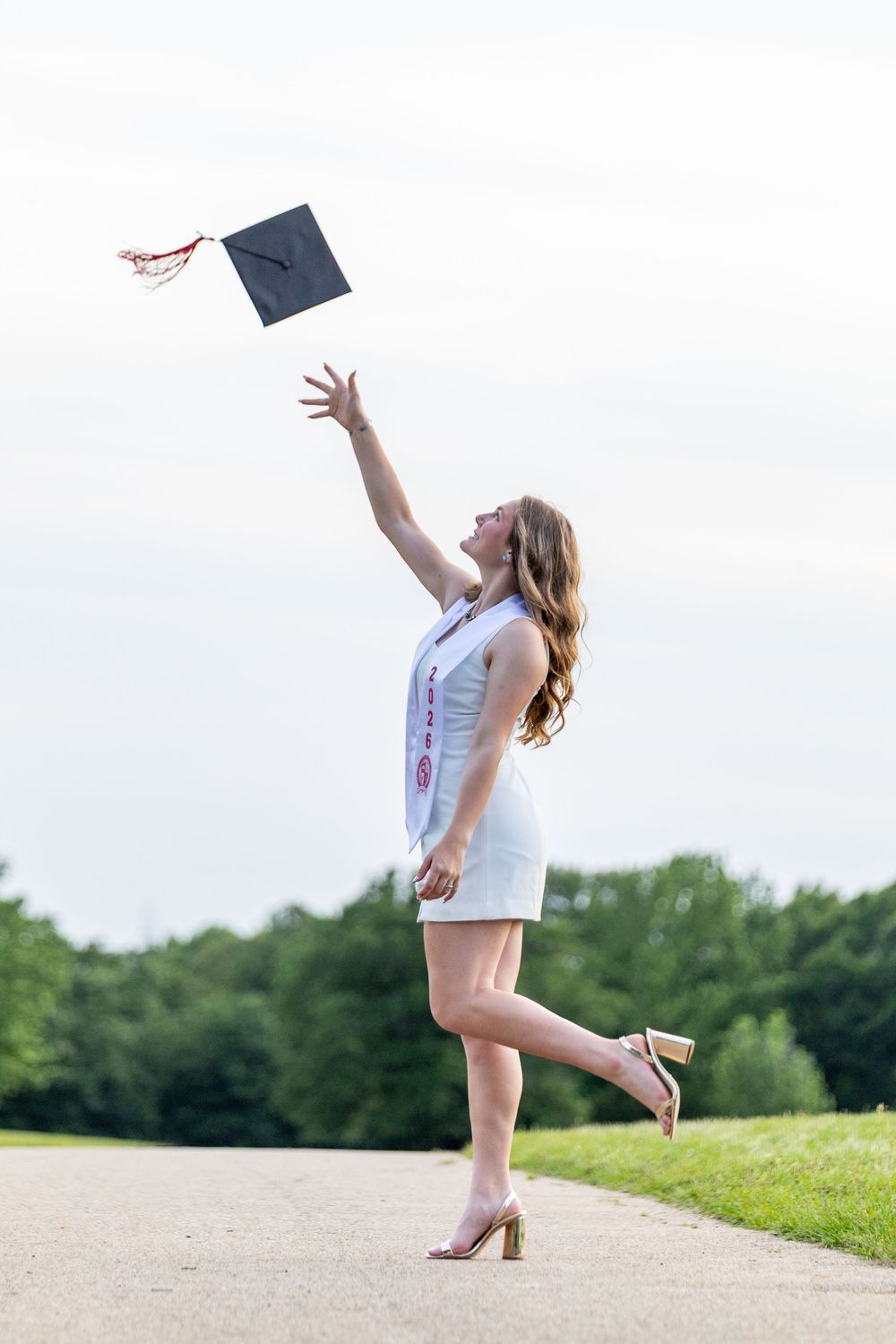 girl tossing graduation cap, senior 2026