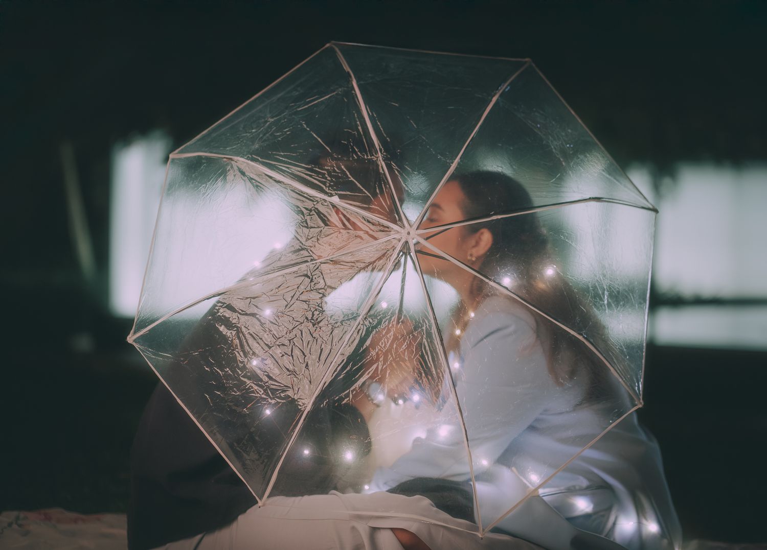 Wedding detail shot featuring geometric clear umbrella with fairy lights creating bokeh effect. Singapore