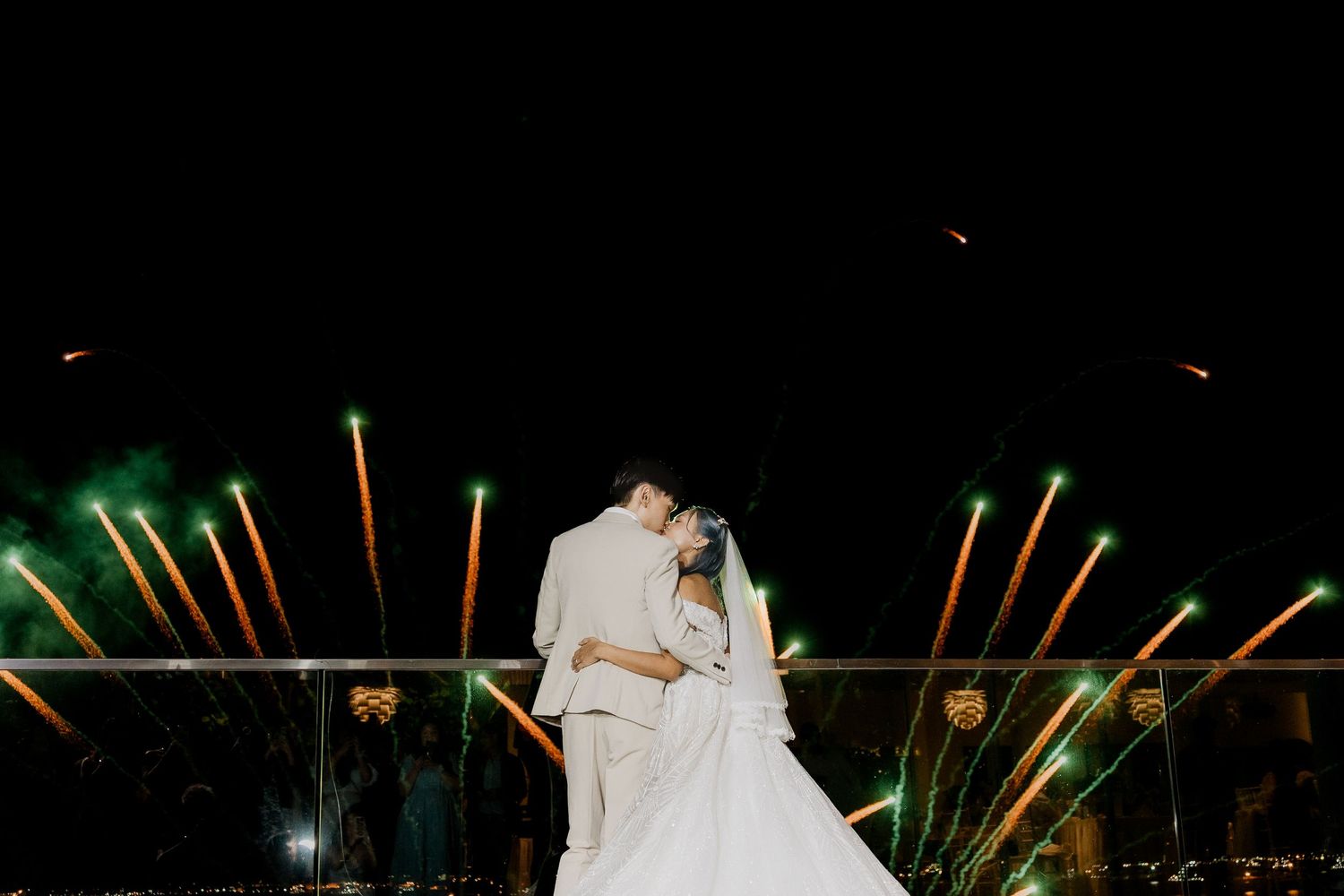 Wedding celebration at night with colorful sparklers creating light trails. Singapore