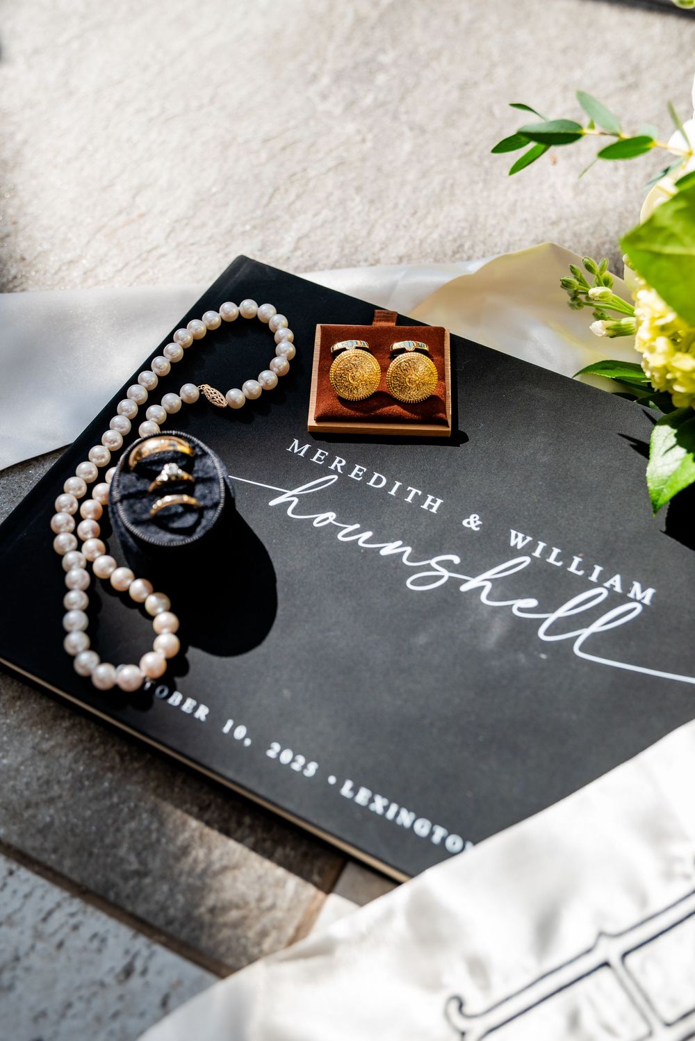 Wedding stationery with pearl necklace and gold cufflinks for Meredith and William Hounshell.