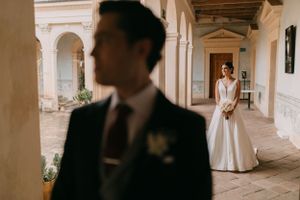 An elegant colonnade walkway with stone columns creates a romantic architectural setting.