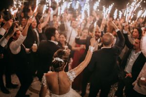 Wedding reception dance floor filled with celebrating guests and sparklers creating a magical atmosphere.