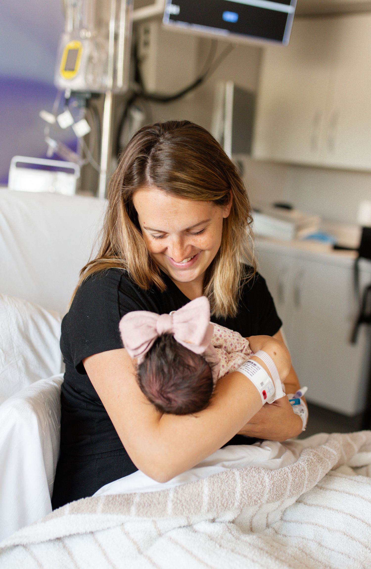 Parents holding newborn during family photos in O’Fallon MO