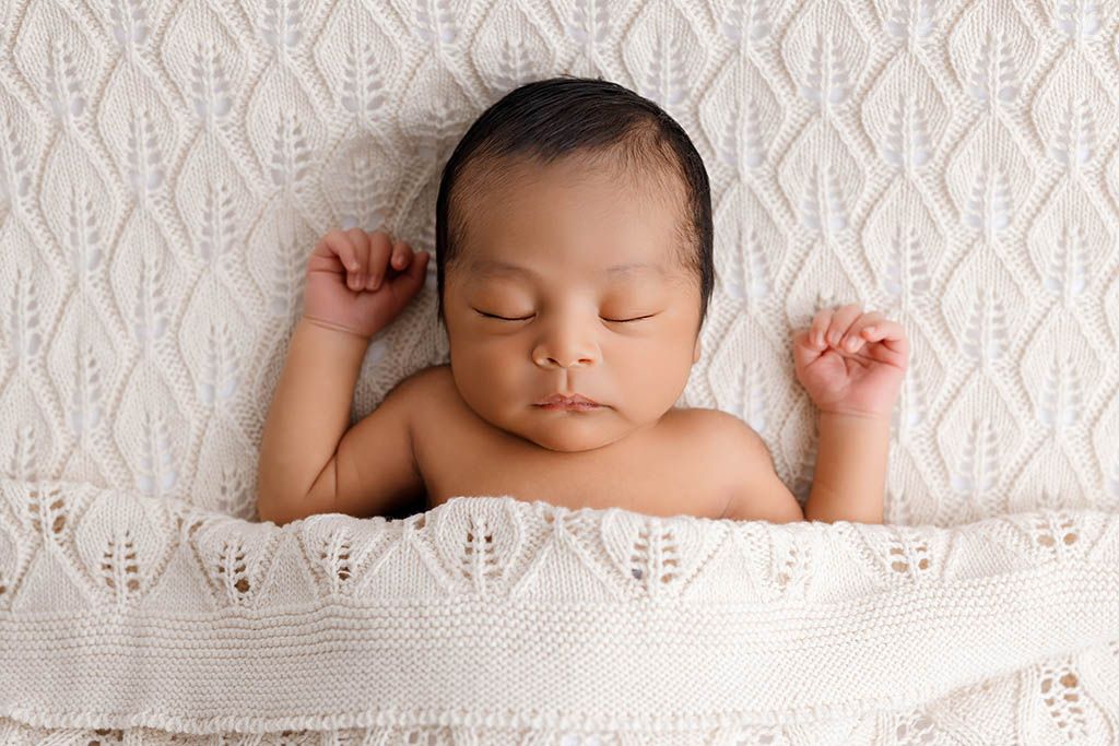 Murrieta CA newborn photographer photo of new baby boy lying on knit blanket.