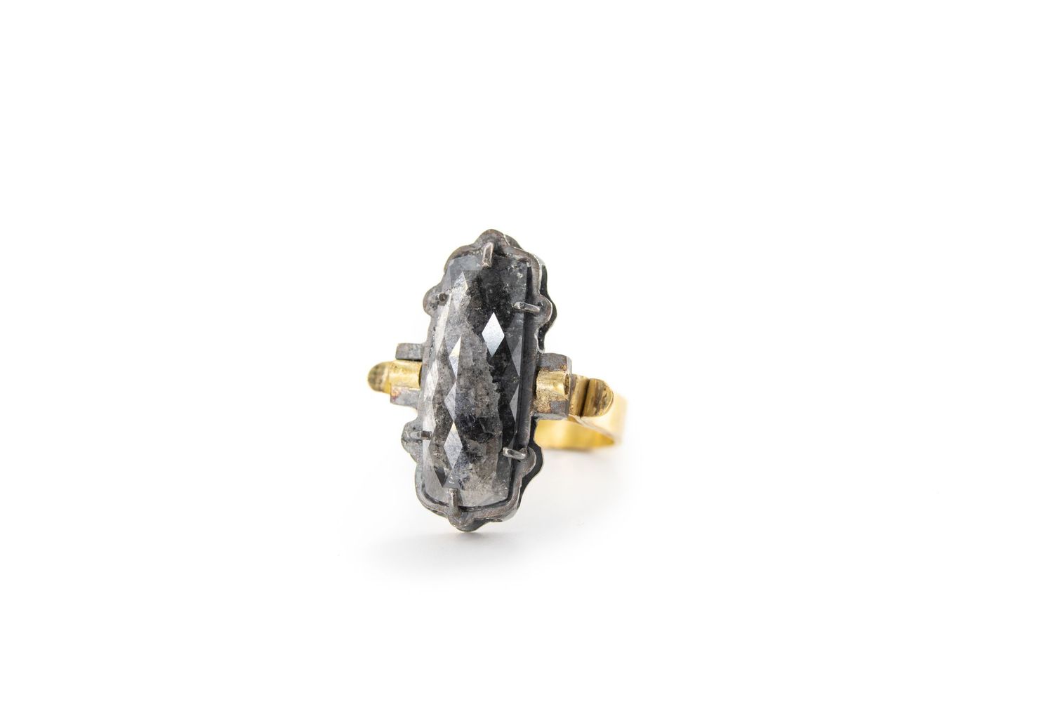 Unique raw diamond ring set in oxidized silver and gold on a white background.