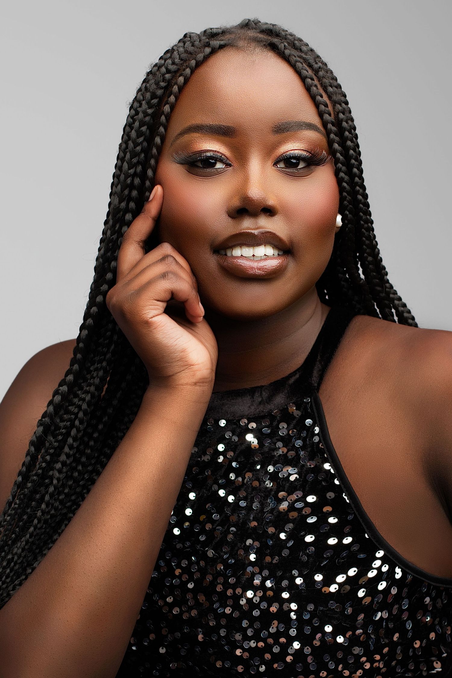 Portrait series showing joyful expressions and beautiful box braids hairstyle against dark background with sparkly top.