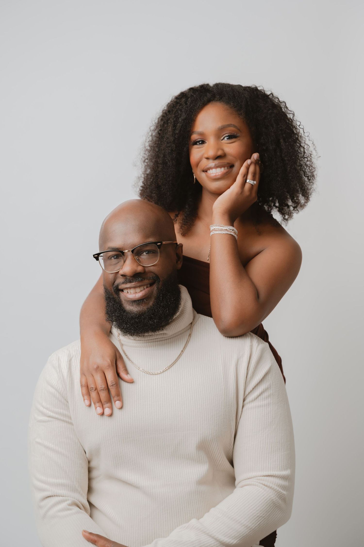 Studio portraits showing joyful expressions and poses against a light gray background.