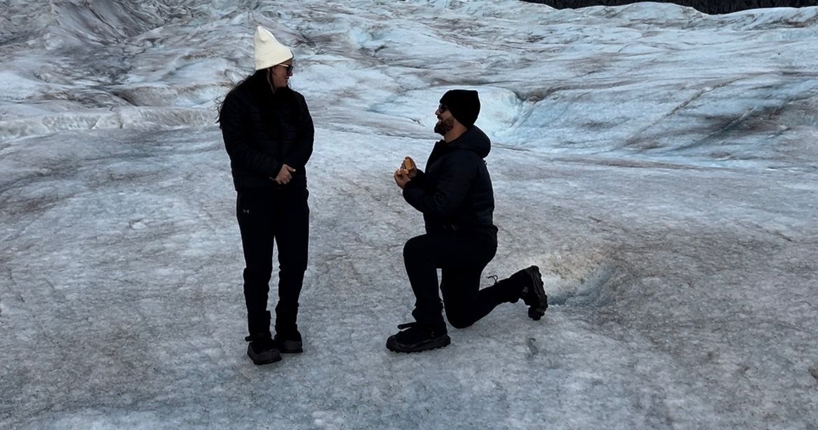 People ice skating on a frozen lake surface during winter activities.
