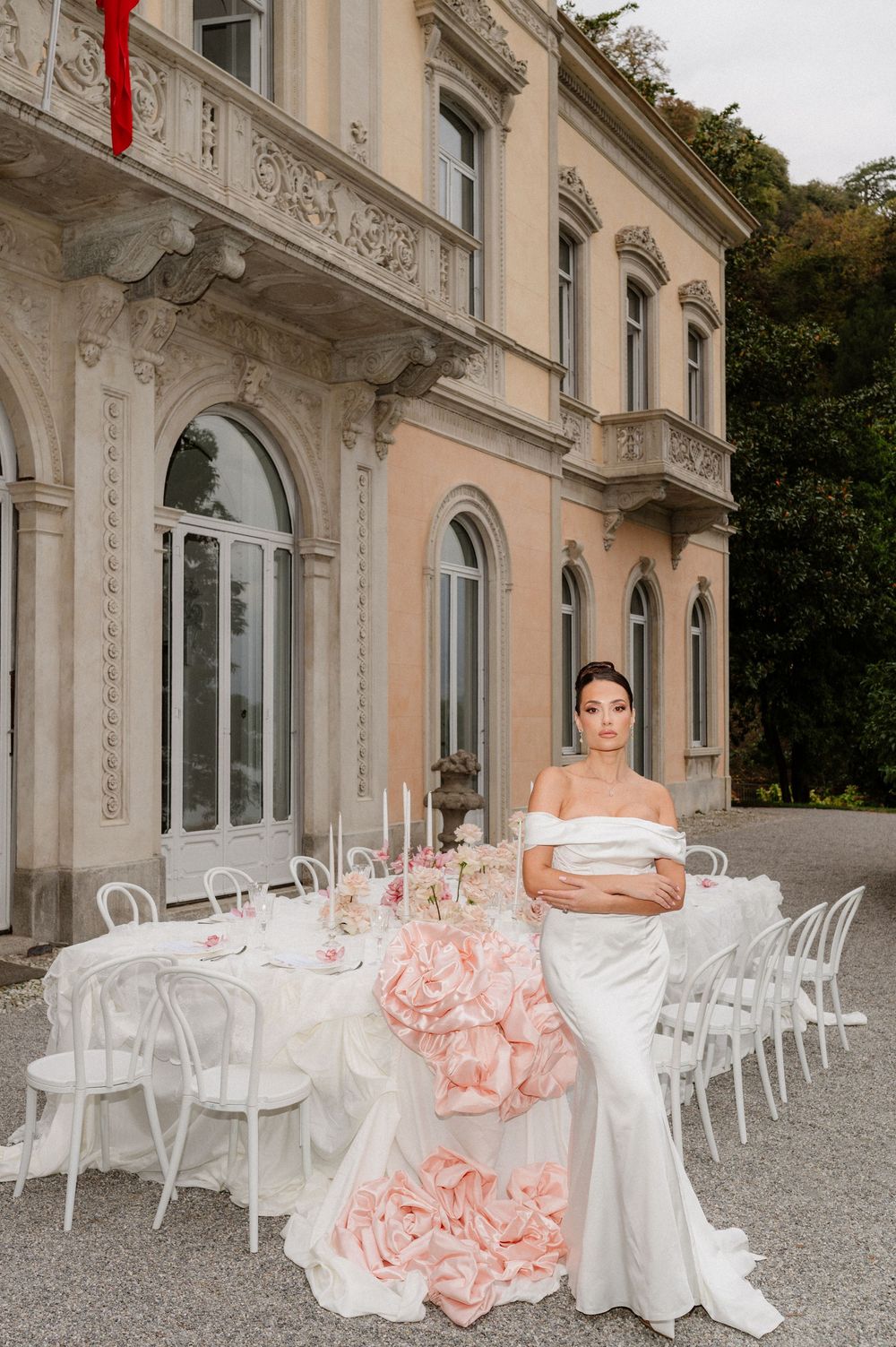 Luxurious white villa exterior with ornate architectural details and elegant wedding reception setup.
