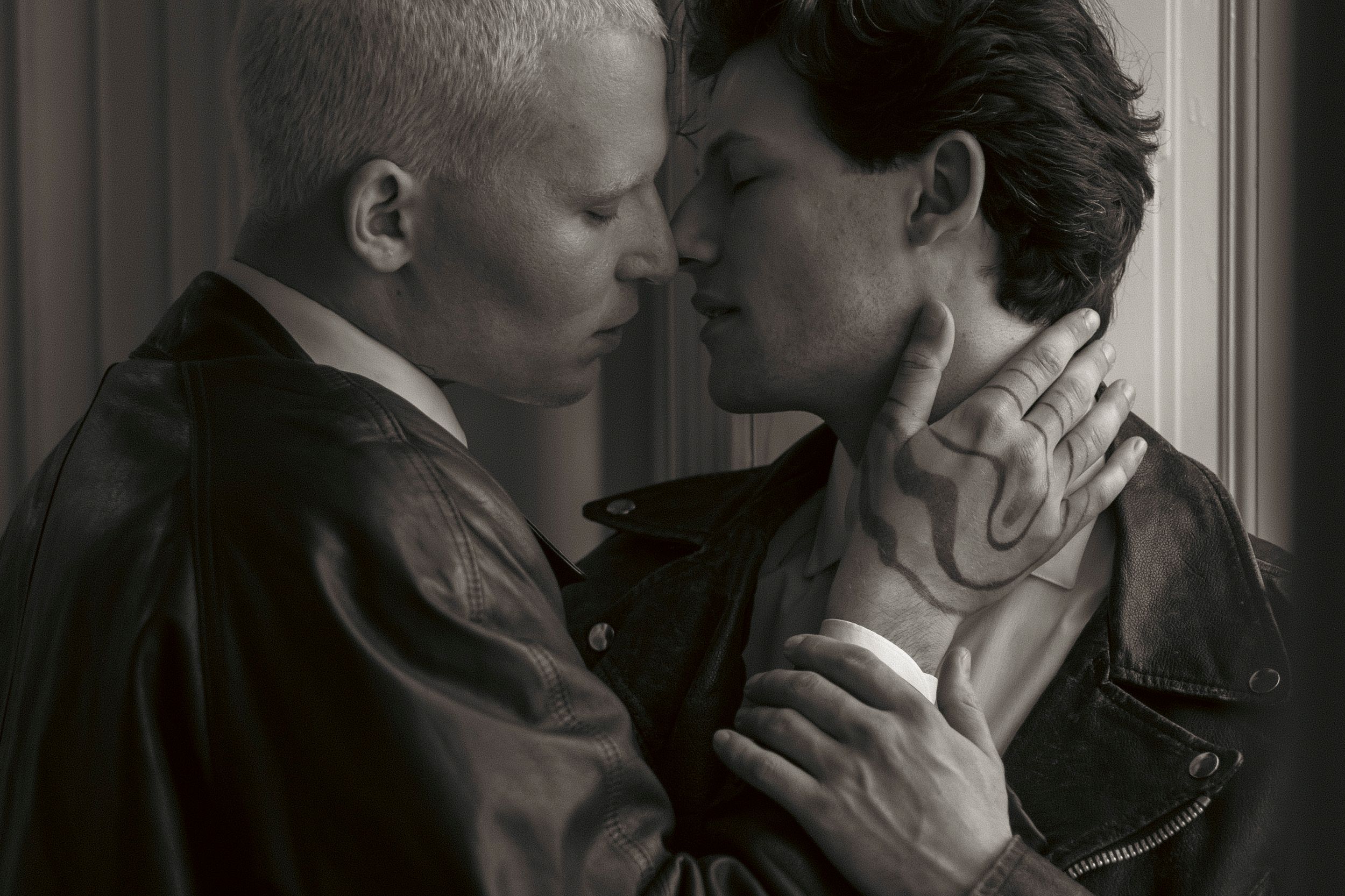 A black and white photo series showing four romantic couples embracing and sharing intimate moments together.