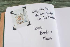 Handwritten wedding guest book pages with personal messages and well wishes.