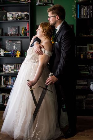 A romantic wedding photoshoot in a cozy library room with green walls.