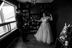 Black and white artistic wedding photos captured in a home setting.