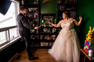 Candid wedding moments captured in a room with green walls and window light.