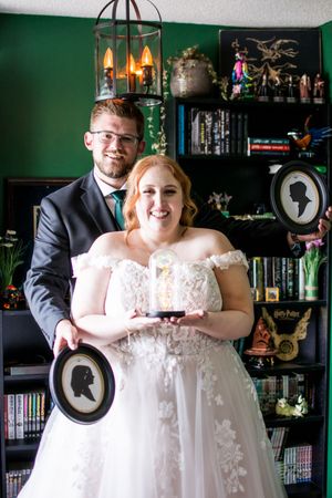 A wedding scene in a room with dark green walls and vintage decor.