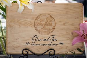 Wooden wedding sign with elegant engraving and floral decorations.