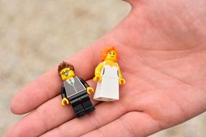 Close-up view of a small LEGO minifigure held in someone's palm.