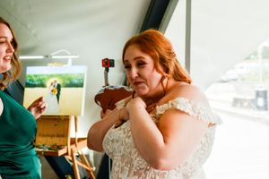Wedding party members sharing laughter and candid moments at indoor reception.