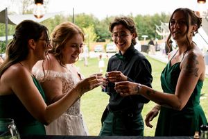Wedding guests enjoying drinks and conversation at an outdoor reception.