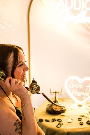 Sequence of candid photos showing person laughing while holding vintage telephone in warm lighting.