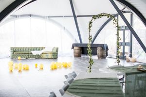 Interior view of a white wedding tent with rows of chairs set up for a ceremony.