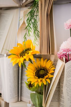 Sunflowers and book pages create an artistic wedding decoration display.