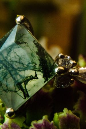 Close-up of crystal gemstones with dark veining patterns.