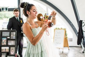 Elegant wedding photos taken under white arched doorway with vintage decor.