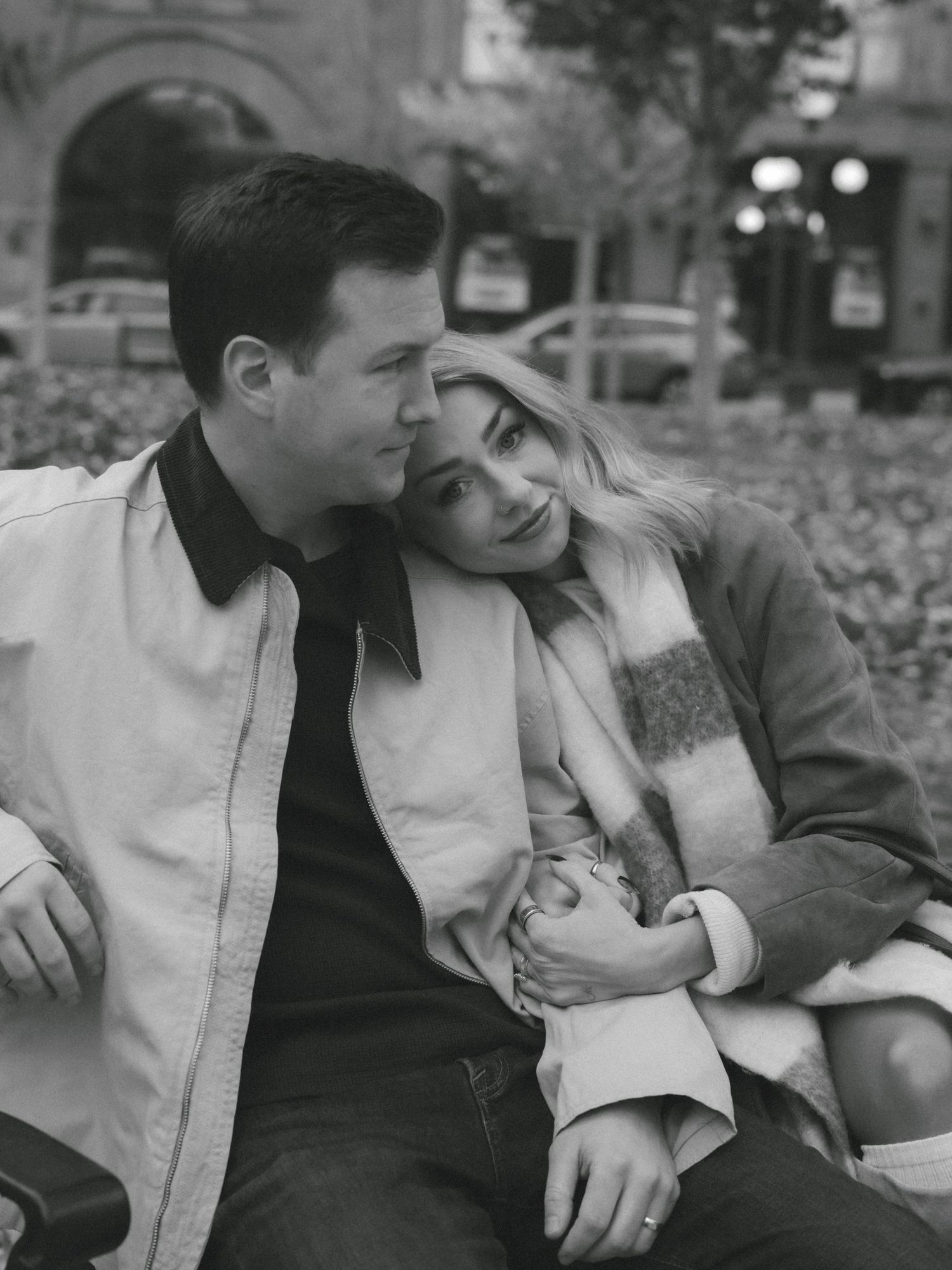 A black and white photo sequence showing two people sitting close together in an intimate conversation.