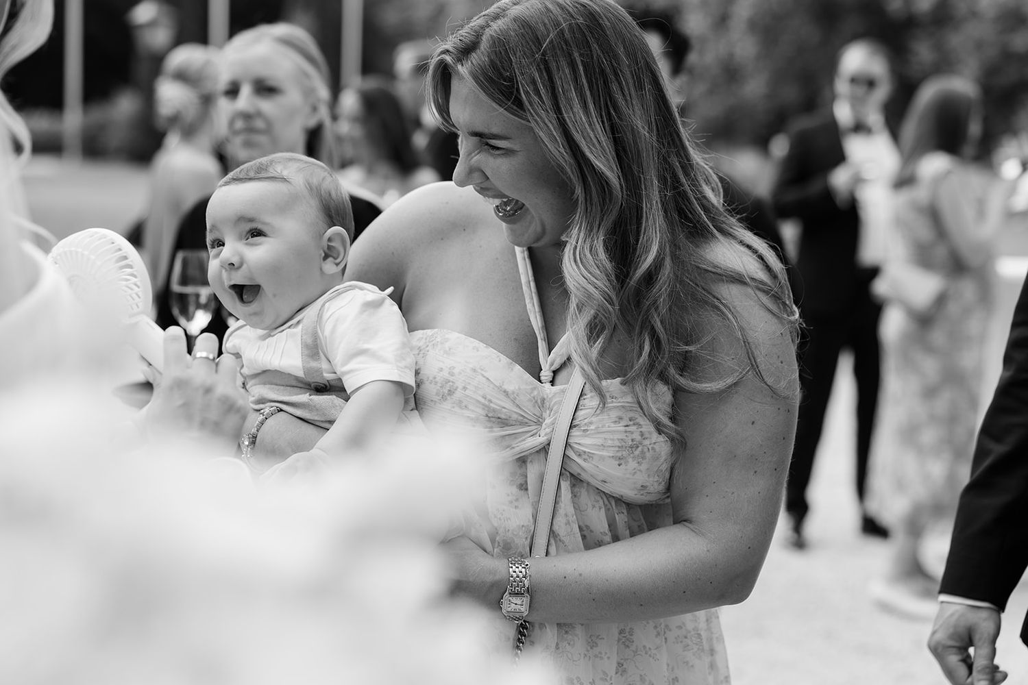 A collage of candid wedding moments showing dancing, hugging and celebrations at a reception.