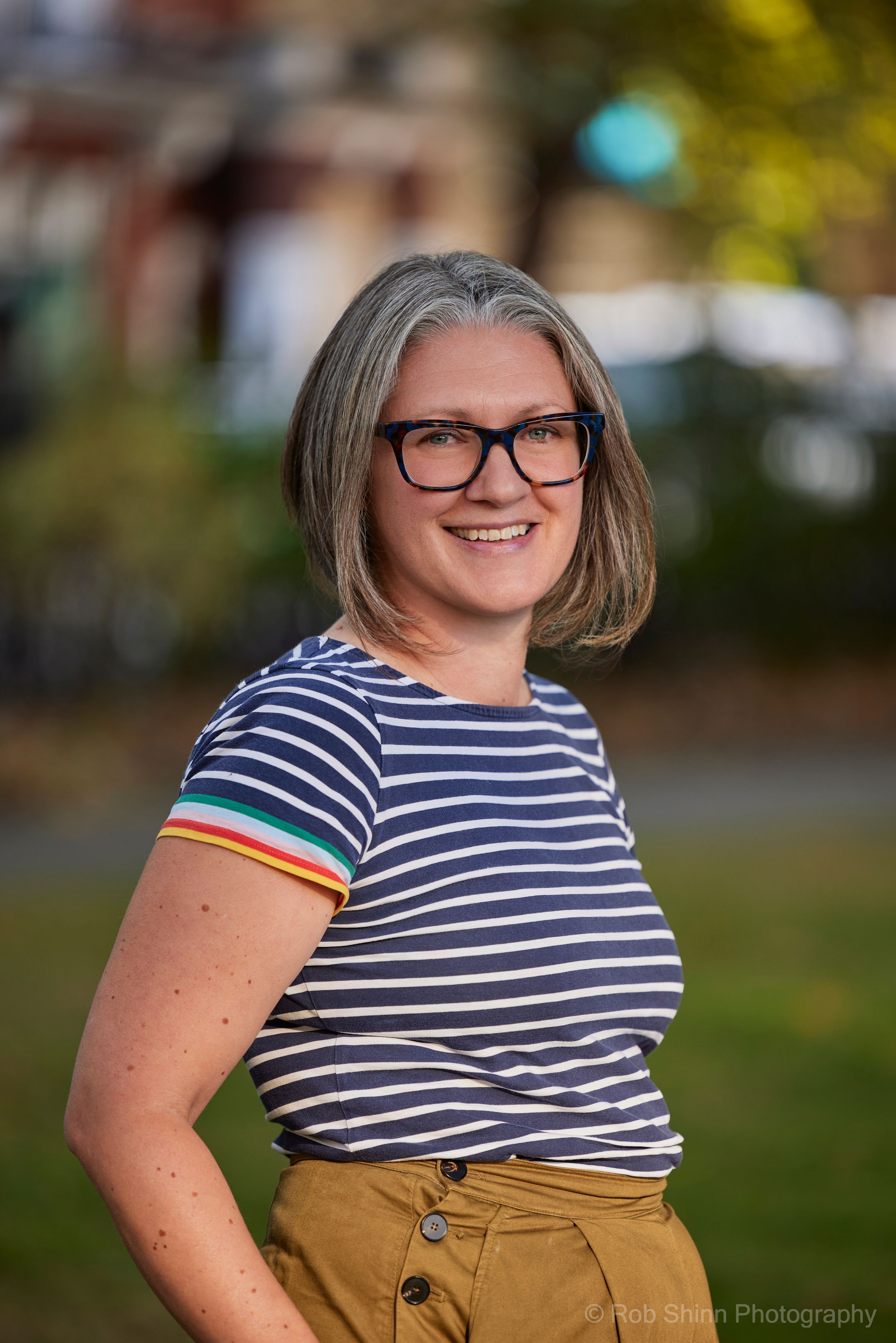 Portrait series showing a striped shirt and mustard skirt against an autumn background.